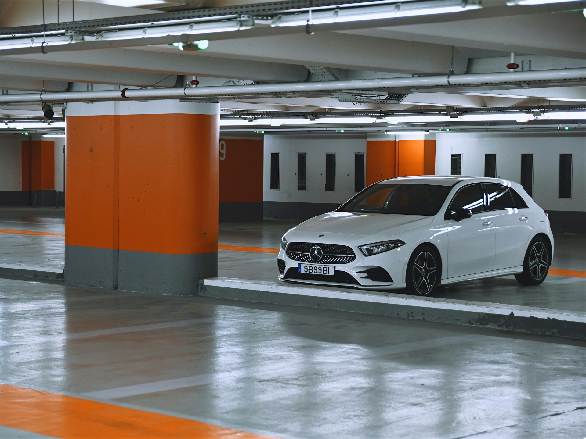 White Mercedes parked indoor car park