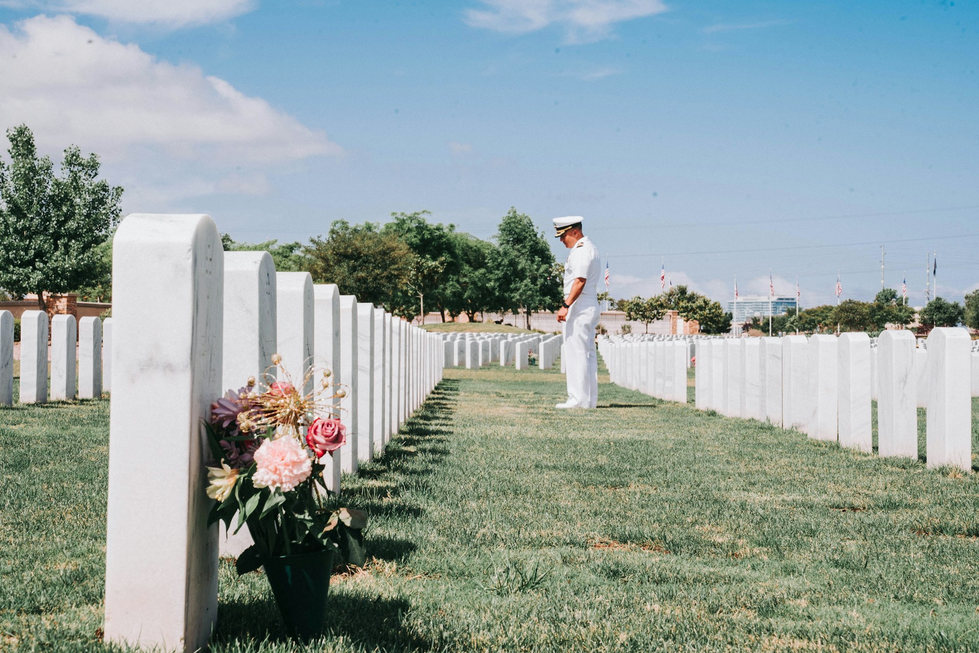 Serviceman paying respect at cemetery