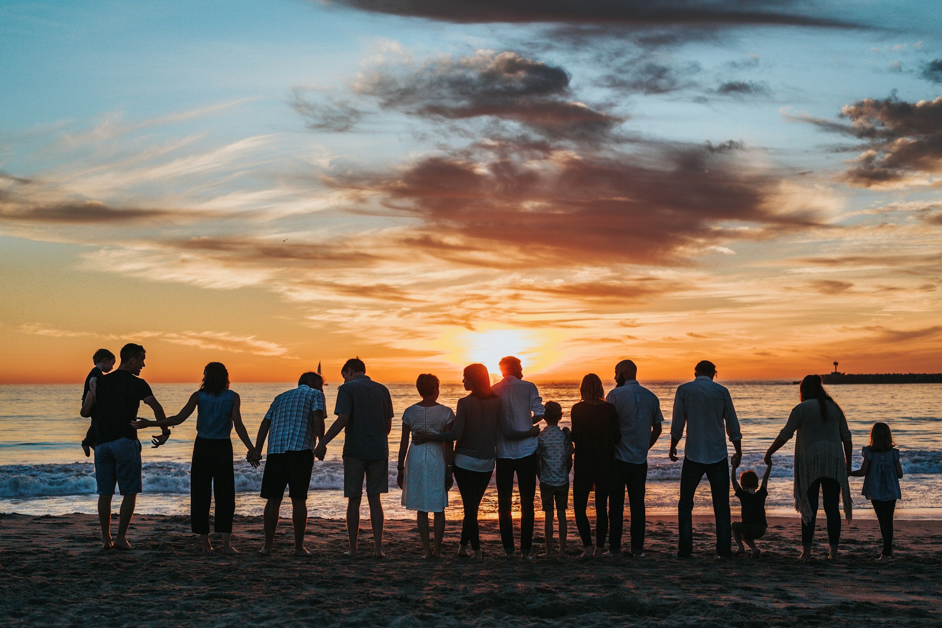 Family reunion on a beach at sunset